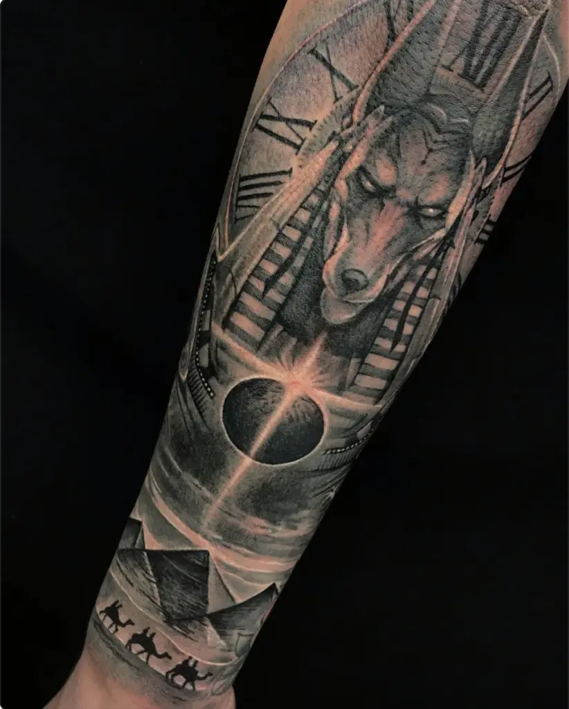 Black and grey Anubis and clock tattoo by Moose, Calgary Tattoo Company