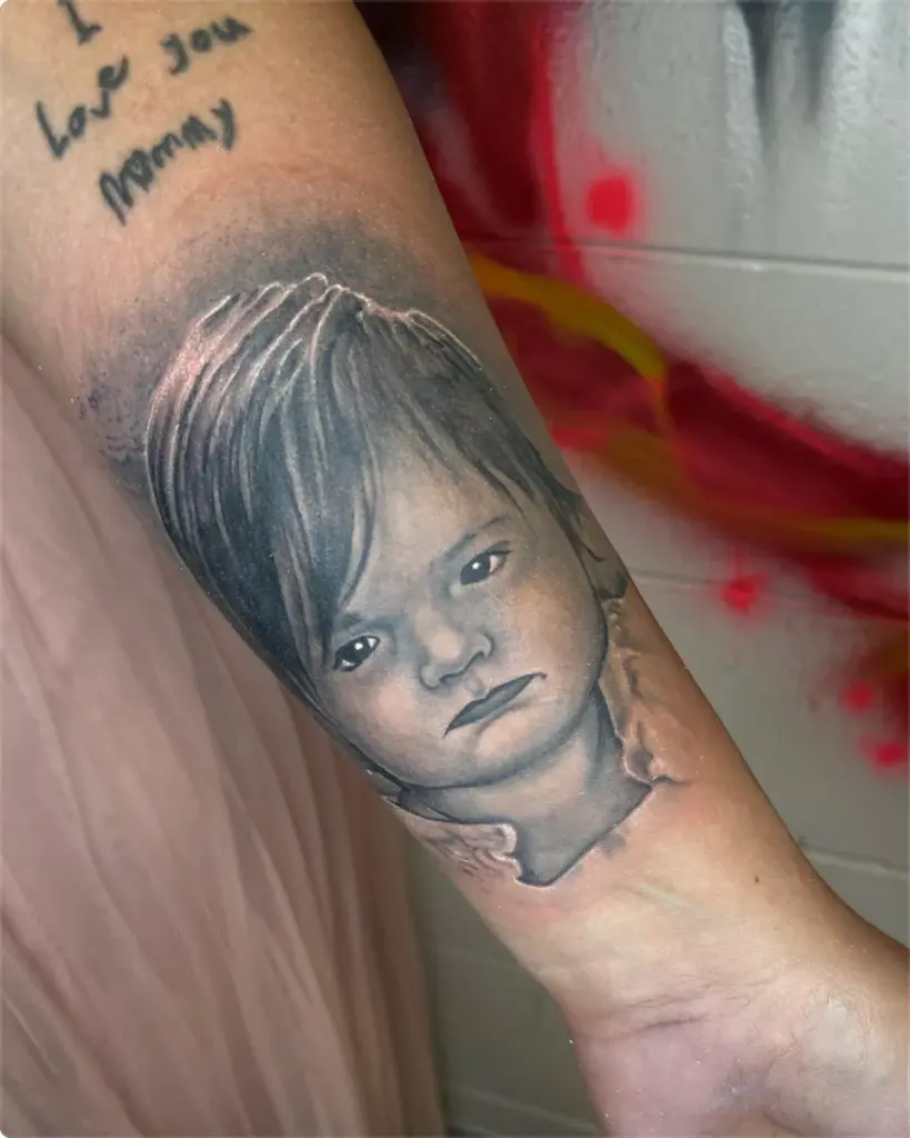 Black and grey child portrait tattoo by Moose, Calgary Tattoo Company