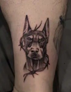 Black and grey doberman tattoo by Kylie, Calgary Tattoo Company