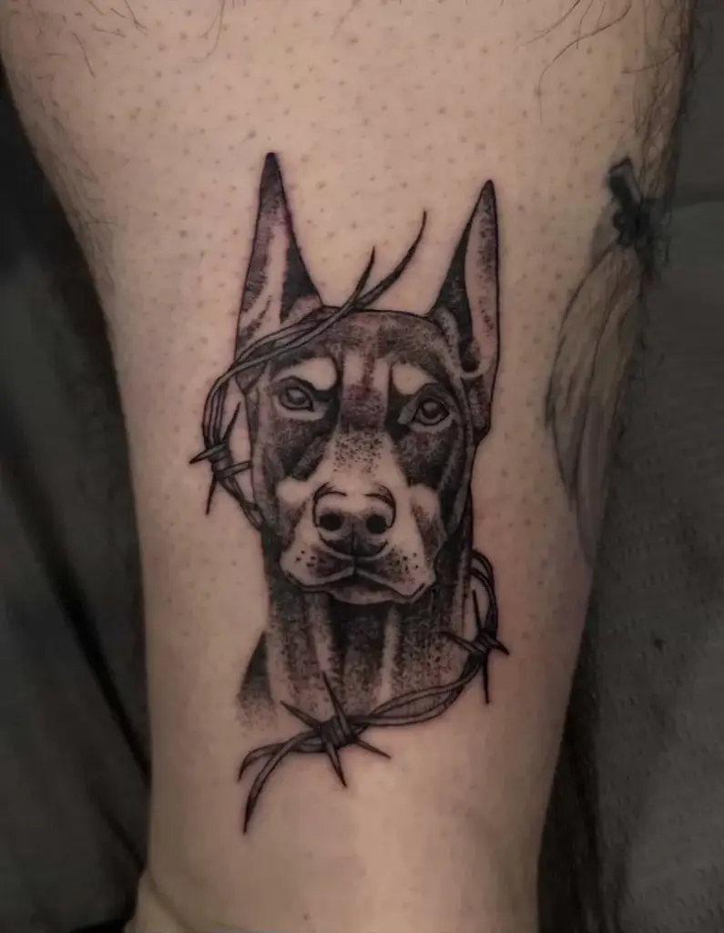 Black and grey doberman tattoo by Kylie, Calgary Tattoo Company