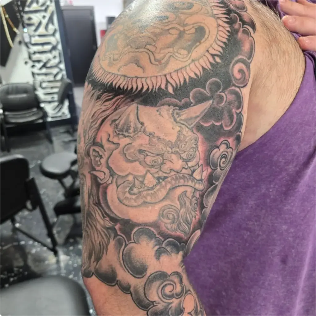 Black and grey foo dog tattoo by Tonka, Calgary Tattoo Company