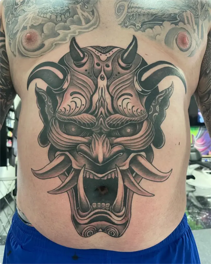 Black and grey hannya mask tattoo by Moose, Calgary Tattoo Company