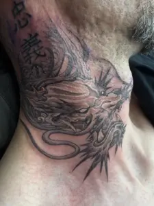Black and grey Japanese dragon and kanji neck tattoo by Moose, Calgary Tattoo Company