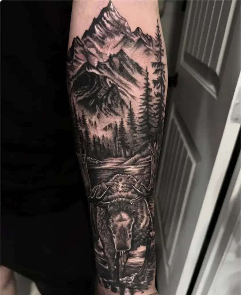 Black and grey moose in a mountain lake tattoo by Kylie, Calgary Tattoo Company