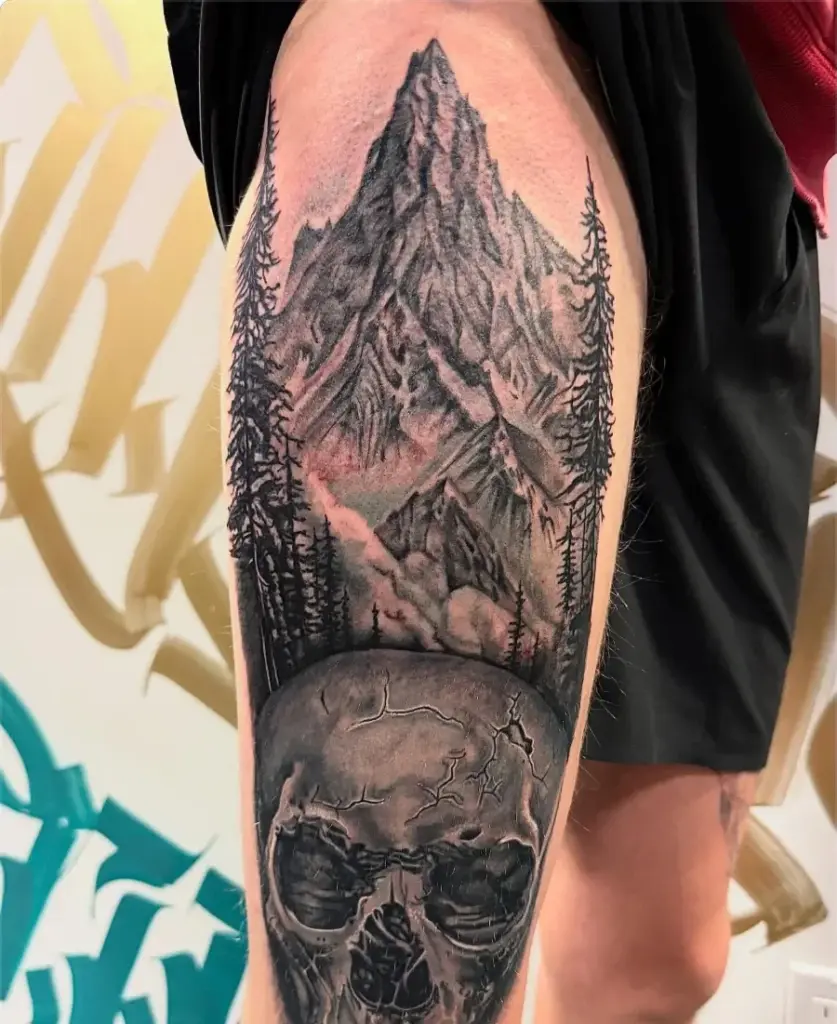 Black and grey mountain and skull tattoo by Kylie, Calgary Tattoo Company
