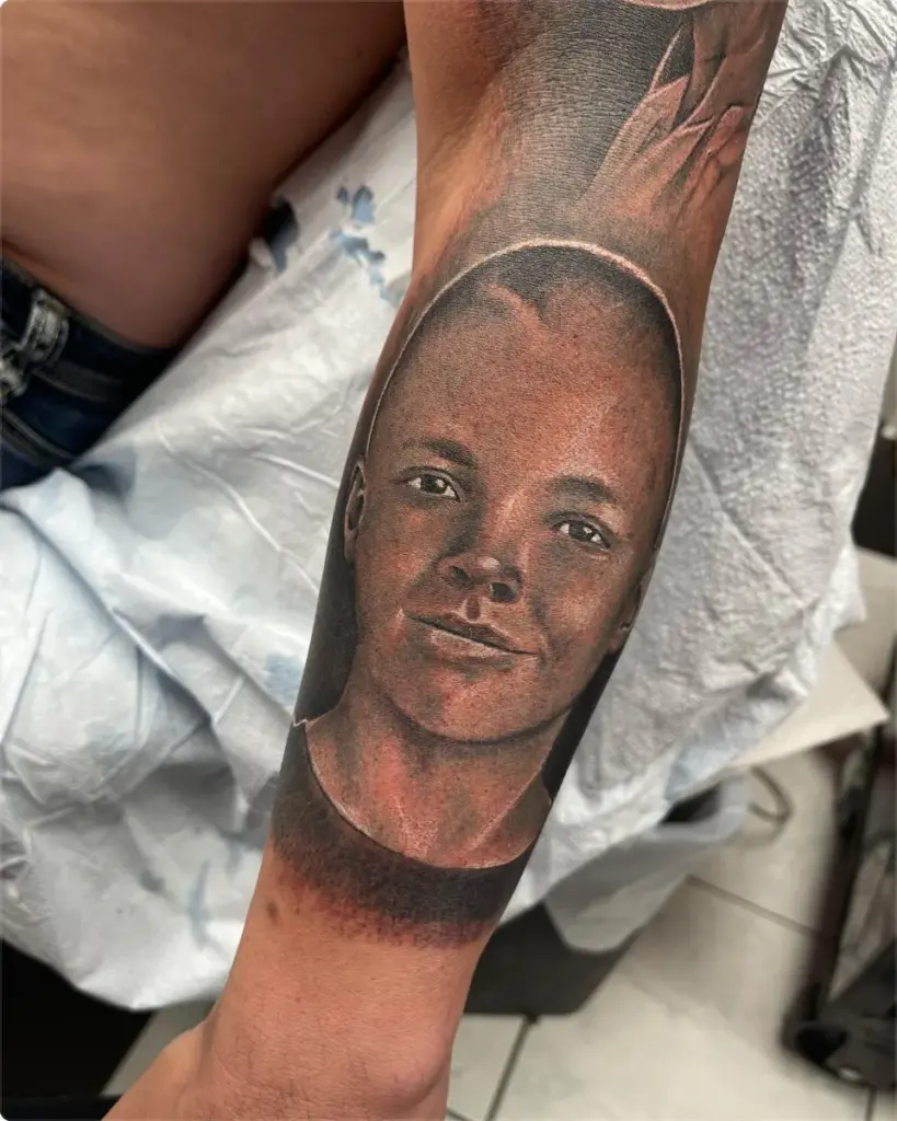 Black and grey portrait of a young man tattoo by Moose, Calgary Tattoo Company