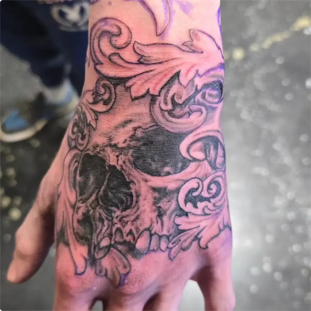 Black and grey skull and filigree tattoo by Tonka, Calgary Tattoo Company