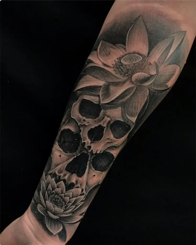 Black and grey skulls and lotus flowers tattoo by Moose, Calgary Tattoo Company