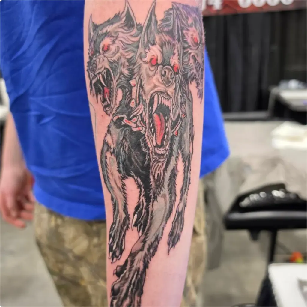 Black and grey three-headed dog tattoo by Tonka, Calgary Tattoo Company