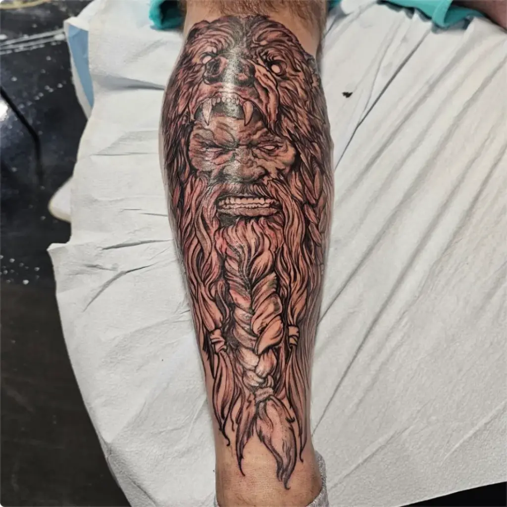 Black and grey viking in a bear hood tattoo by Tonka, Calgary Tattoo Company