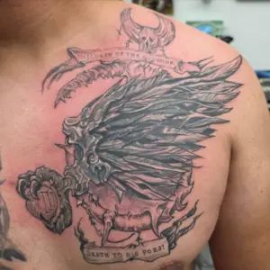 Black and grey winged skull chest tattoo by Tonka, Calgary Tattoo Company
