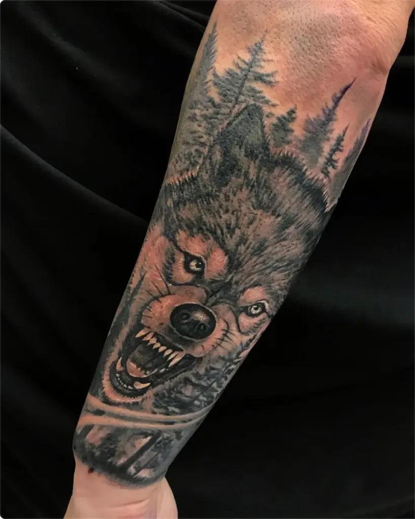 Black and grey wolf and pine forest tattoo by Moose, Calgary Tattoo Company