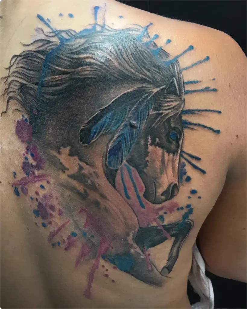 Colour paint horse with feathers tattoo by Moose, Calgary Tattoo Company