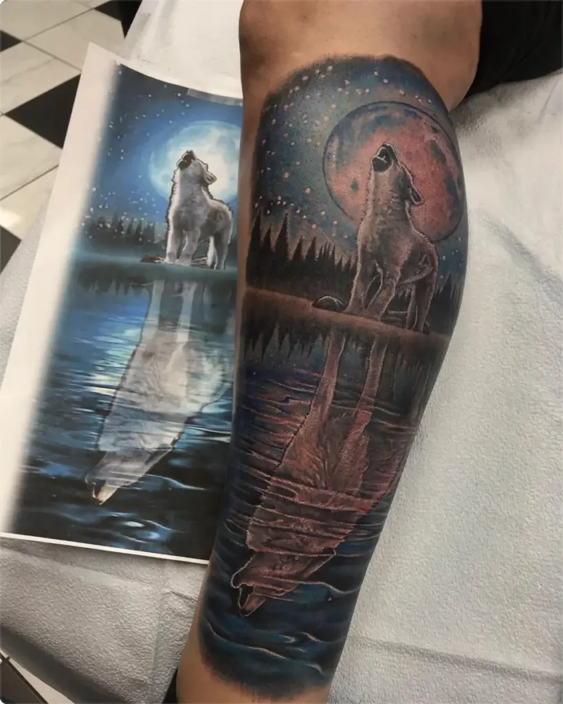 Colour wolf howling at a red moon tattoo by Moose, Calgary Tattoo Company