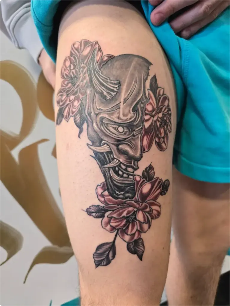 Hannya mask with red peonies tattoo by Tonka, Calgary Tattoo Company