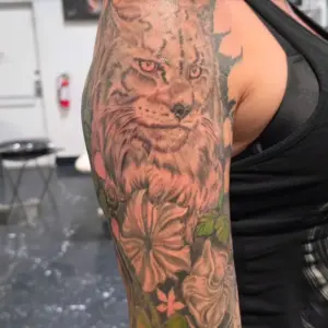 Lynx and flowers sleeve tattoo by Tonka, Calgary Tattoo Company