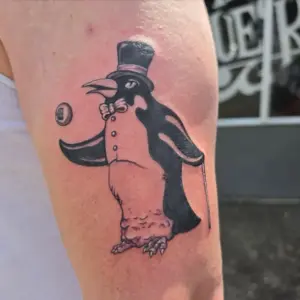 Penguin in a top hat tattoo by Tonka, Calgary Tattoo Company