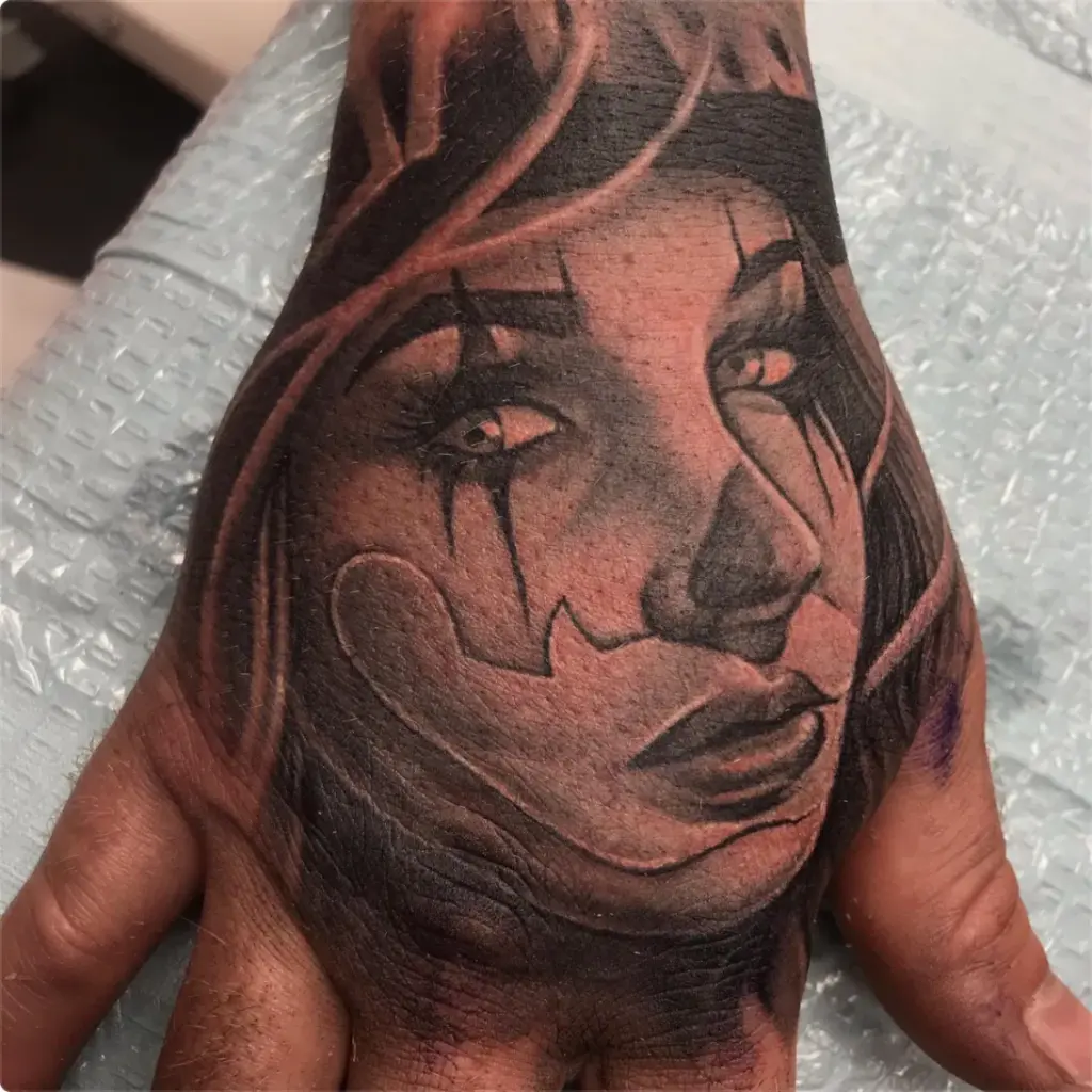 Portrait of a woman's face on a hand tattoo by Moose, Calgary Tattoo Company