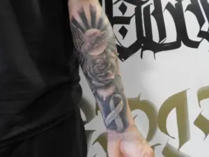 Rose and ribbon tattoo by Keith, Calgary Tattoo Company