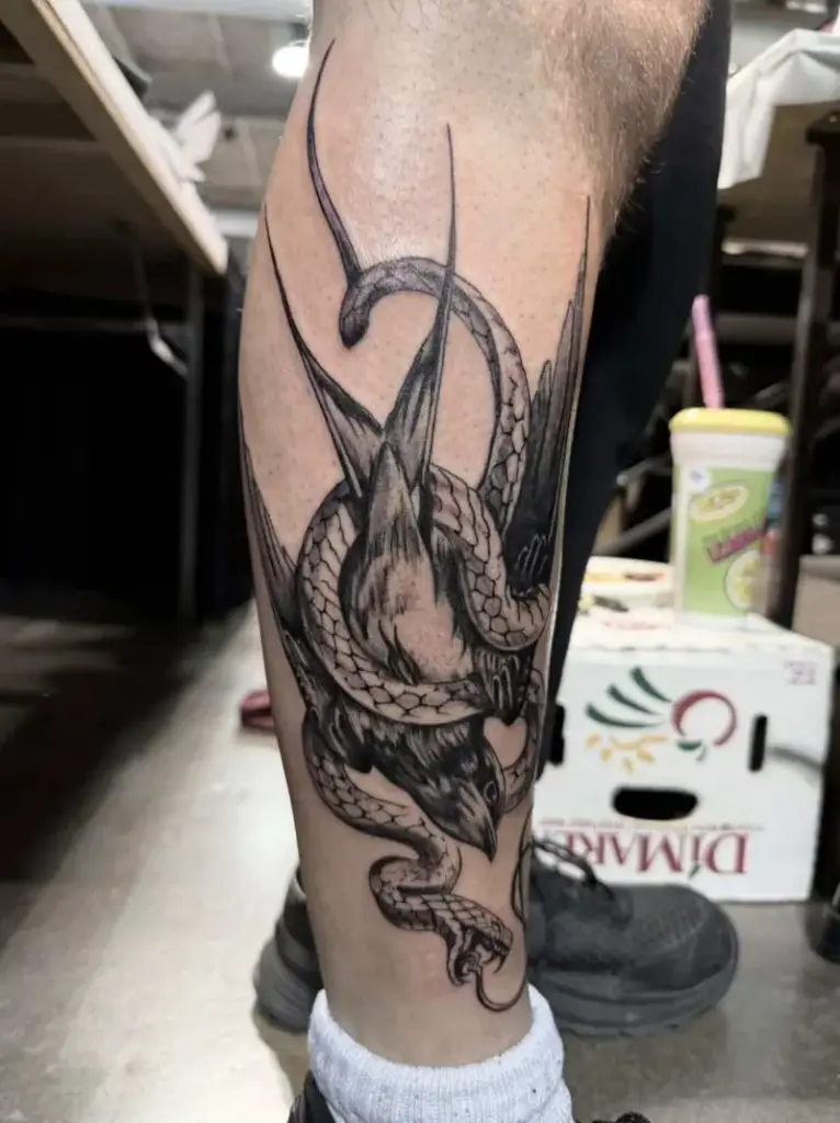 Snake and bird tattoo by Kylie, Calgary Tattoo Company
