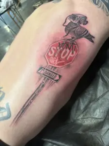 Stop sign and bird tattoo by Moose, Calgary Tattoo Company
