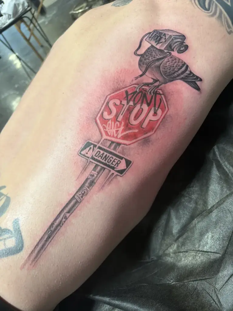 Stop sign and bird tattoo by Moose, Calgary Tattoo Company